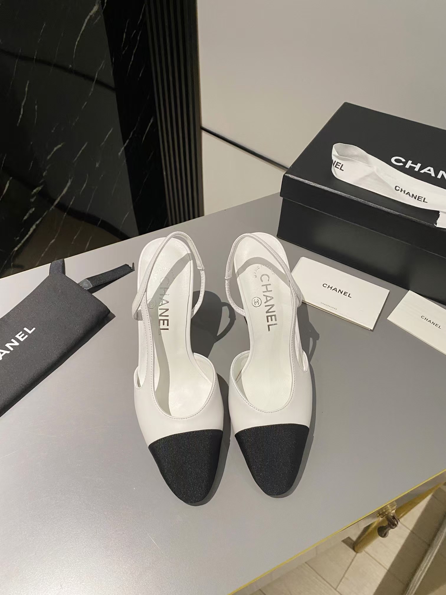 Ch*el two-tone cap toe slingback pumps