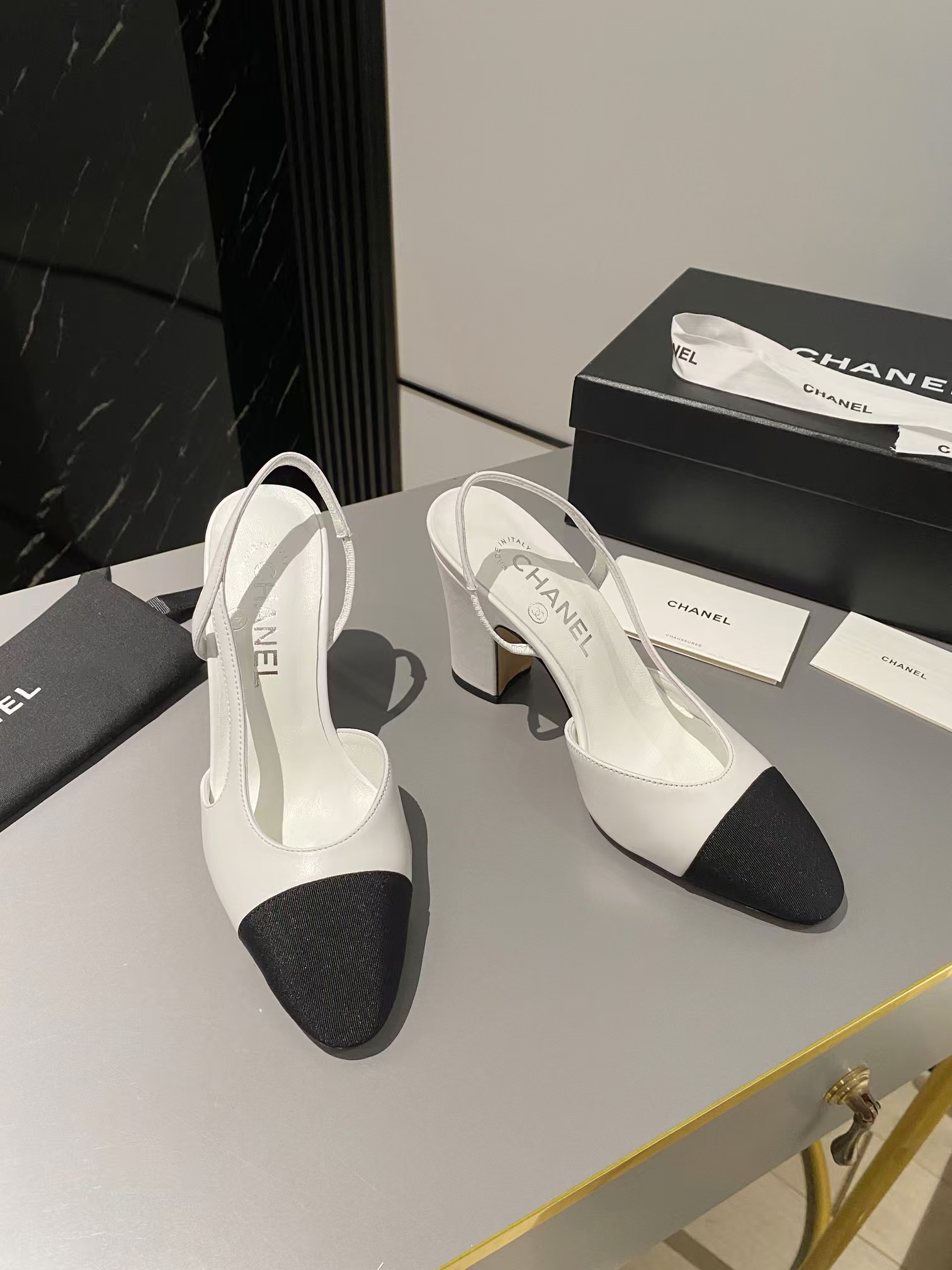 Ch*el two-tone cap toe slingback pumps