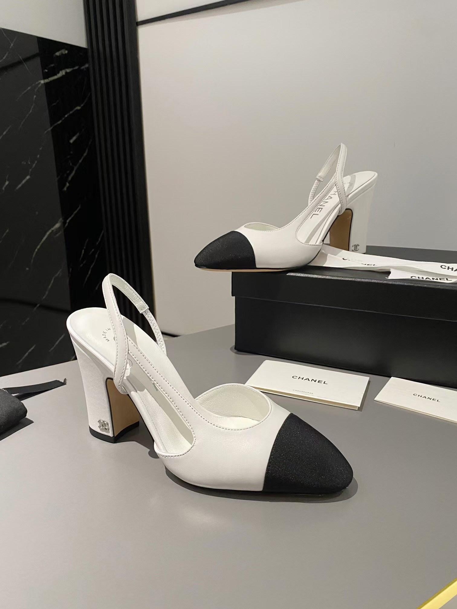 Ch*el two-tone cap toe slingback pumps