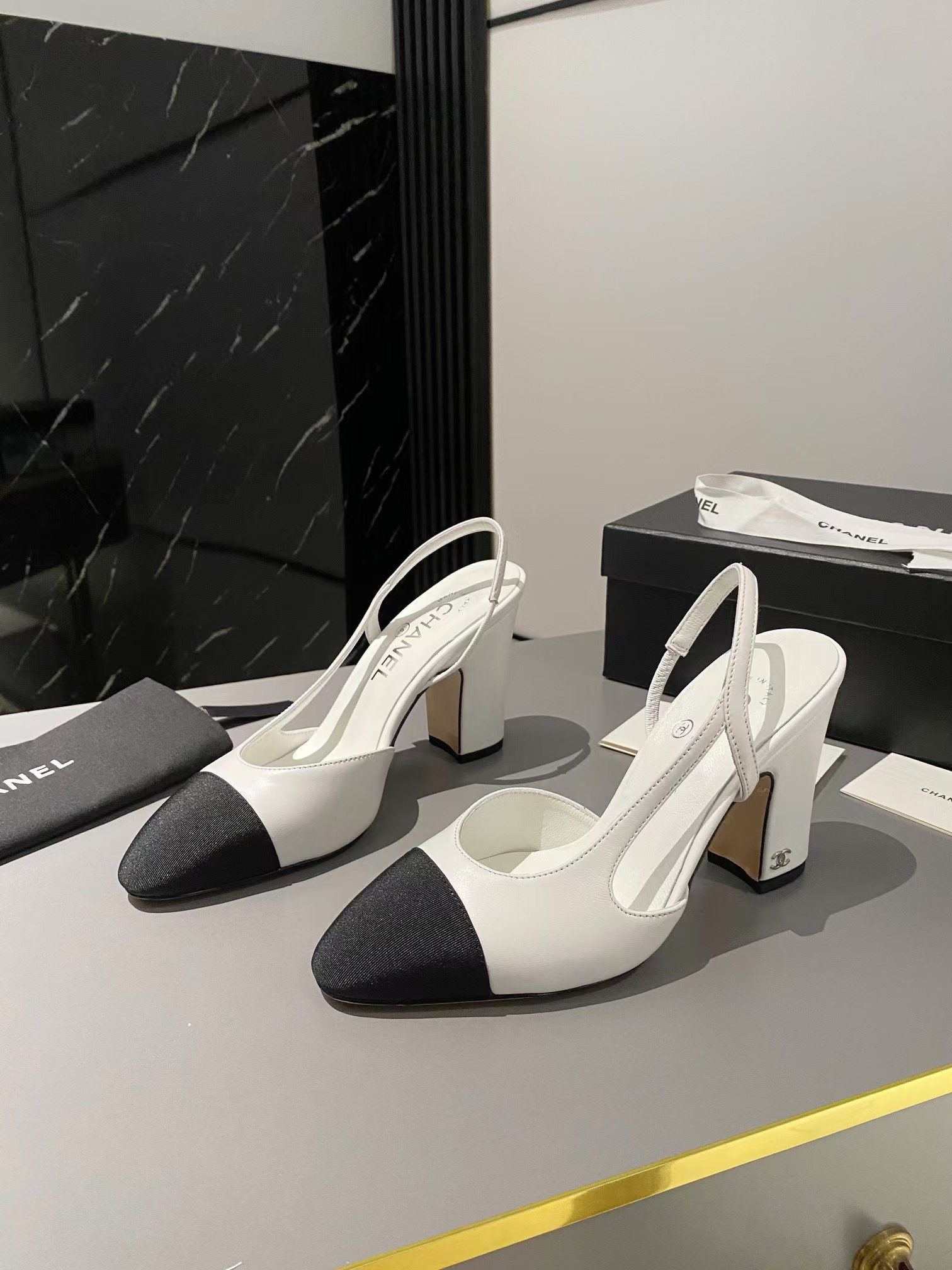 Ch*el two-tone cap toe slingback pumps